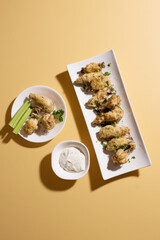 Chicken Wing Appetizer with Garlic Parmesan and Celery Sticks 