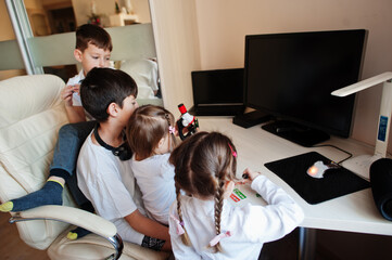 Kids using microscope learning science class at home.