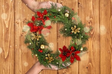 florist hands holding Christmas wreath. Christmas wreath workshop.