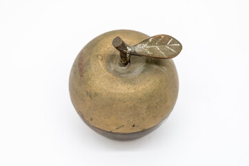 An Apple Made Using Metal Sits Isolated Against A White Background.