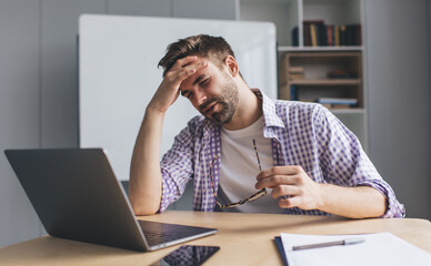 Millennial businessman working at desk in office