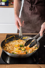Chef cooking delicious udon wok.