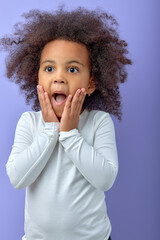 Photo of black little kid amazed shocked omg wow fake novelty reaction isolated over purple color...