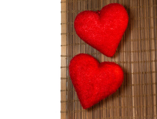 Two red hearts on a wicker background. Postcard for valentine's day. Congratulation. Romantic background.