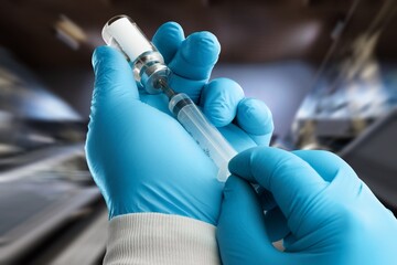 Doctor or scientist filling a syringe with liquid vaccines booster. covid-19 coronavirus,...