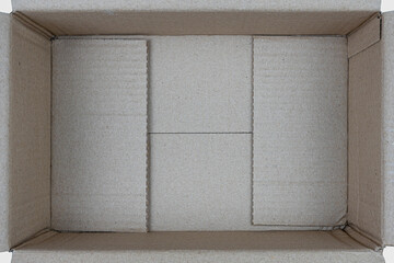 Open empty rectangular cardboard box on white background. Close up, Top view