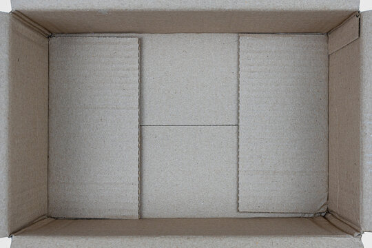 Open empty rectangular cardboard box on white background. Close up, Top view