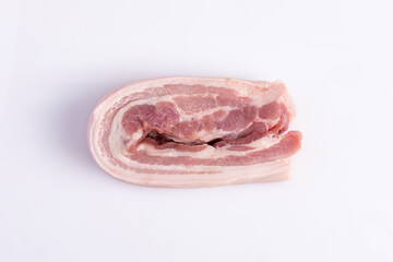 Close up freshness cutting slide pork belly raw or streaky pork on white background. .A meat boneless cut of fatty meat from the belly of a pig. This dish is considered a delicacy in many countries.