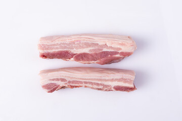 Close up freshness cutting slide pork belly raw or streaky pork on white background. .A meat boneless cut of fatty meat from the belly of a pig. This dish is considered a delicacy in many countries.