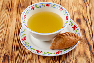 Hot meat broth with fresh cereal bun