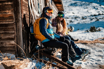 Mountaineer backcountry ski walking ski woman alpinist in the mountains. Ski touring in alpine landscape with snowy trees. Adventure winter sport. Freeride skiing - obrazy, fototapety, plakaty