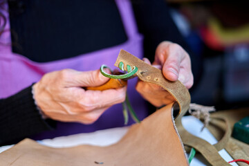 Detail shot Unrecognizable craftswoman working leather