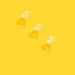 Martini glasses with vermouth, sugar and lime in beautiful row line on yellow background.