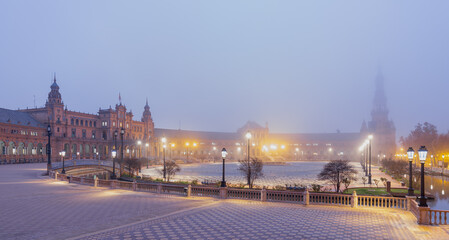 The famous Spanish square in Seville during a sunrise covered in fog. It is built in 1928 for the Ibero-American Exposition. It is a landmark with regionalism architecture and mixing elements.  - obrazy, fototapety, plakaty
