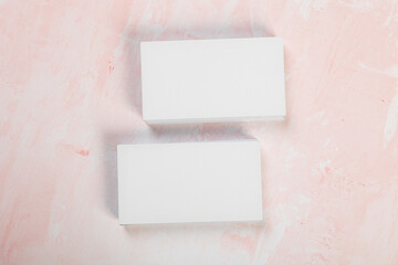 Blank business cards. Mock up on pink marble background. Copy space for text.