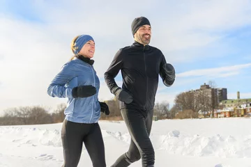  mature couple in the winter running together in nature © Louis-Photo
