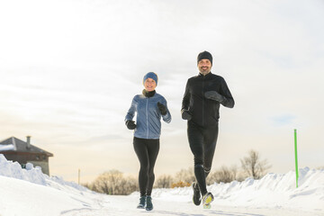 mature couple in the winter running together in nature