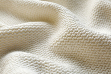 Beautiful white knitted fabric as background, closeup