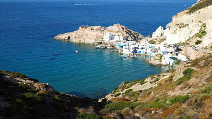 Beautiful fishermen seaside village and small sandy beach of Firopotamos with colourful boat houses called "Syrmata", Milos island, Cyclades, Greece