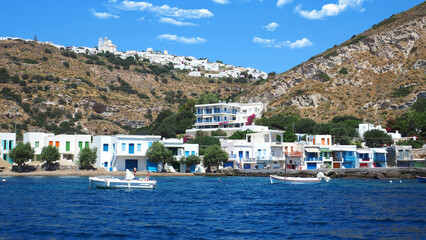 Beautiful fishermen small scenic seaside picturesque village of Klima in entrance of port of Adamantas with colourful boat houses called 