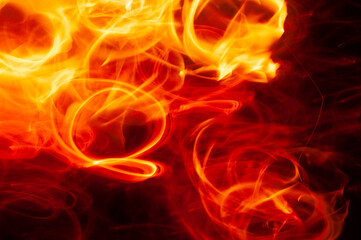 Fototapeta premium Flames of fire from a bonfire, with abstract shapes and in movement
