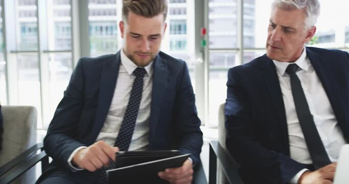 Your source of information matters a lot. Diverse businesspeople using digital devices while sitting in an office lobby. Colleagues waiting in queue for opportunity, interview, conference or meeting