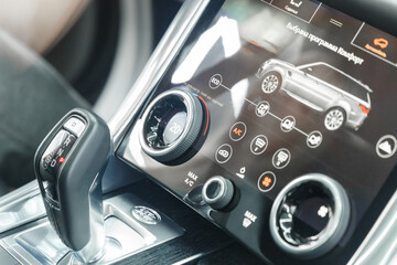 Modern interior of a new car. Luxurious modern interior of the car. Automatic transmission lever. Car control display with touch screen. Close-up of the car interior.