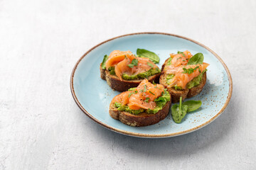 Salmon avocado keto sandwiches on healthy seed buns.