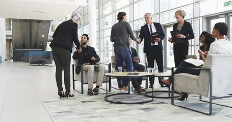 The more people you connect with, the better your chances are. Diverse businesspeople shaking hands while meeting in an office lobby or convention centre. Team of colleagues networking and greeting - Powered by Adobe