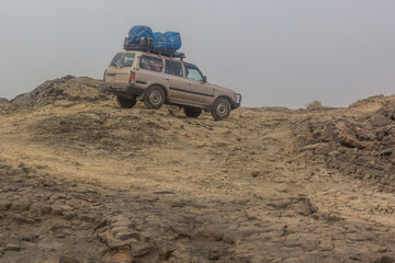 Vehicle crossing lava fields on its way to Erta Ale volcano in Afar depression, Ethiopia