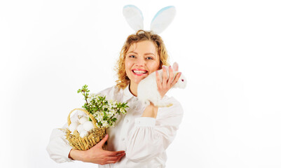 Smiling woman in rabbit ears with basket eggs and bunny. Happy Easter day. Eggs hunt. Spring holiday.