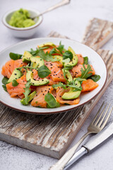 Fresh salmon salad with avocado,  for keto and low carb diet. Rusty background, top view, copy...