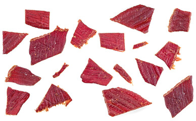 Beef jerky pieces isolated on a white white background, top view. Dried meat.