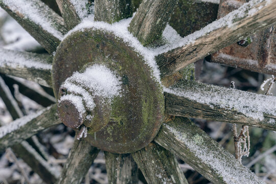 old chariot wheel in the snow