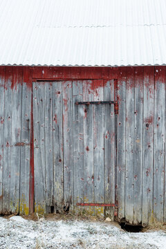 wooden door of abandoned summer barn in winter