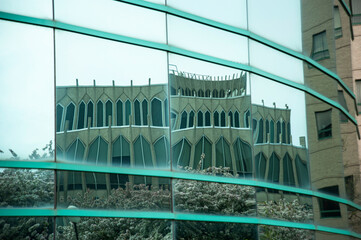 Reflection of architecture of a building from another glass building in spring in Detroit, Wayne...