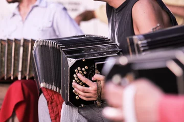 Poster Close-up of Argentine bandoneon player performing on the street playing tango music with orchestra in Buenos Aires, Argentina. © ideasRojas 