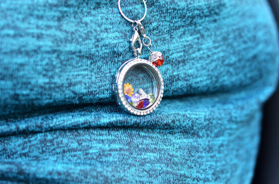 Silver And Glass Locket Hanging On A Neck With Mom Dangle And Charms Inside Portrait Style