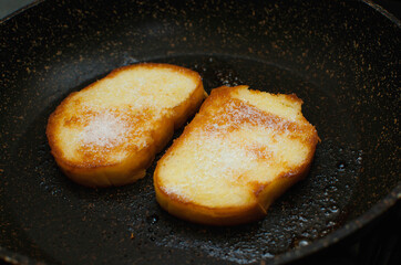 Toast fried in egg and sprinkled with sugar, close-up
