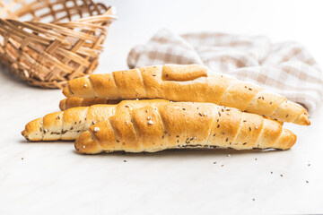 Baked croissant. Crispy bun roll on white table.