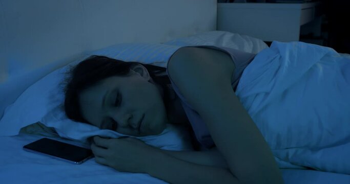 Woman lying in bed at night suffering from severe depression and anxiety suffers from insomnia
