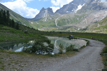 Naklejka na ściany i meble mountain lake in the shadow of the alps of the Italian Mount Blanc region of Val Veny in summer