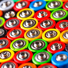 Fototapeta premium Energy abstract background of colorful batteries.Used batteries from different manufacturers, waste, collection and recycling,Alkaline battery aa size.Concept background of colorful batteries