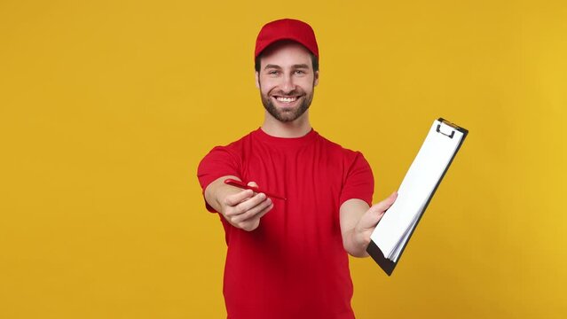 Professional delivery employee man in red cap T-shirt uniform work as dealer courier give you clipboard with papers document pen isolated on plain yellow background studio portrait. Service concept