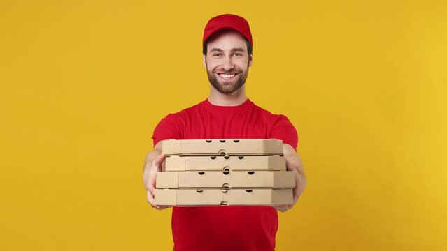 Fun professional delivery employee man in red cap T-shirt uniform work as dealer courier run go give you pizza in cardboard flatbox isolated on plain yellow background studio portrait. Service concept