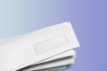 White envelopes on the background, made of paper, used to enclose letters or document.