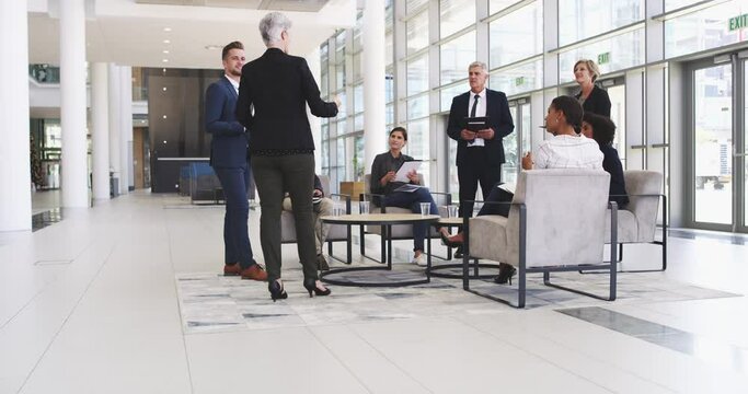 Group of diverse businesspeople talking having a meeting at work.