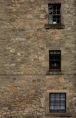 Fototapeta na wymiar Three Windows on Stone Wall