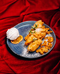 Tasty fried bananas and icecream on blue plate