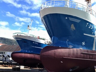Two big boat bows. Drydock at port. Summer day. Tromsø, Norway